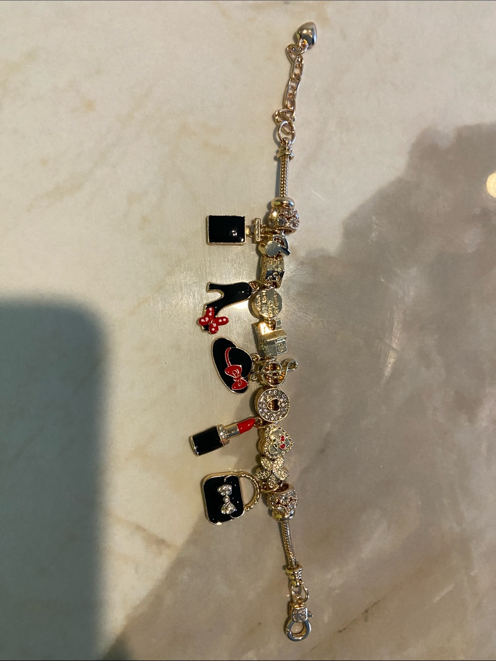 Gold-Tone Charm Bracelet with Black and Red Enamel Accents